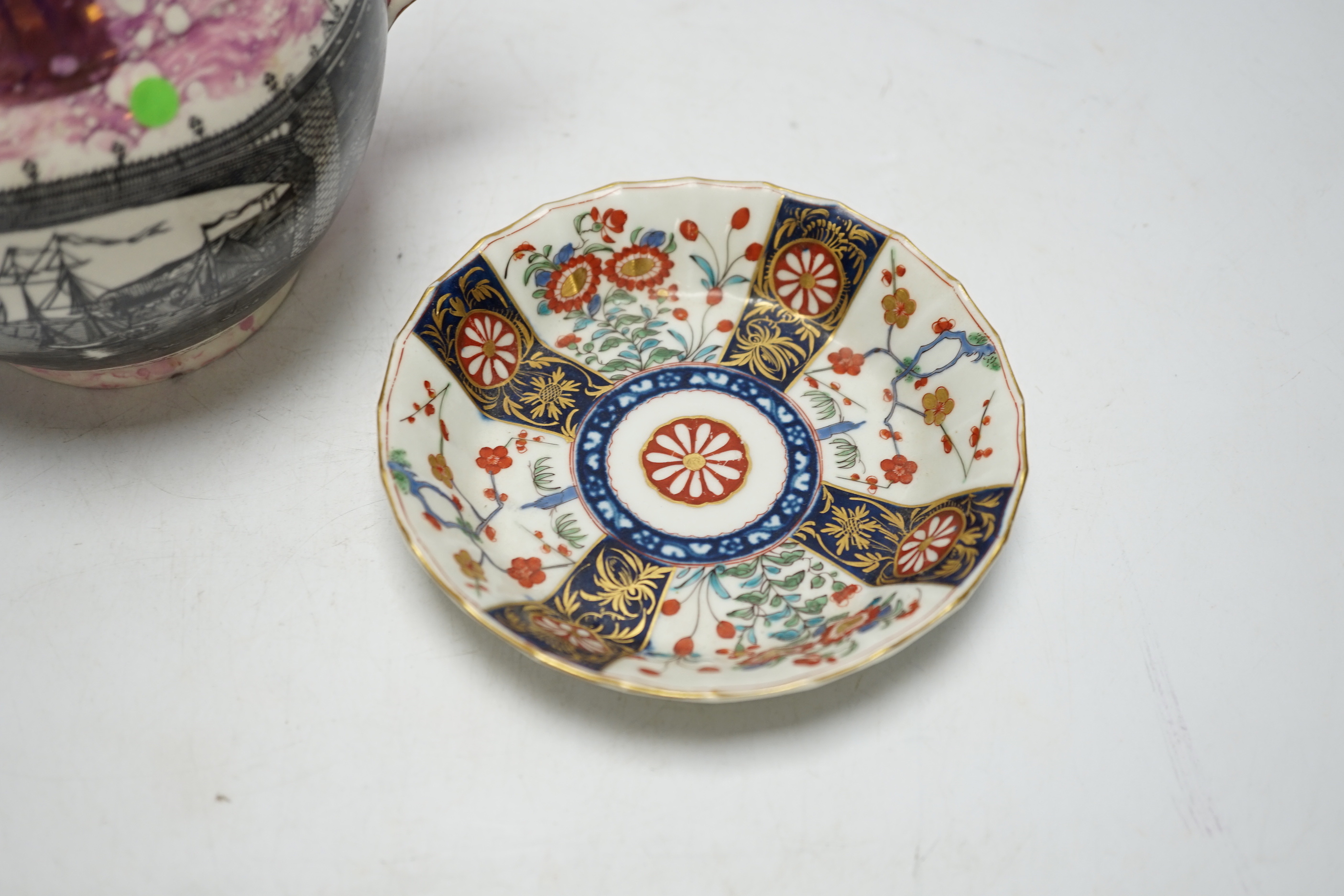 A Worcester Kakiemon pattern coffee cup and saucer, c.1780 and Gray’s Pottery pink lustre ‘’Iron Bridge Sunderland’’ jug, (3), 13cm